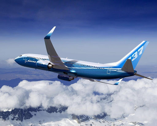 Boeing 737 aircraft in flight above clouds